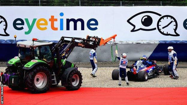 Pierre Gasly's Honda is recovered from the track