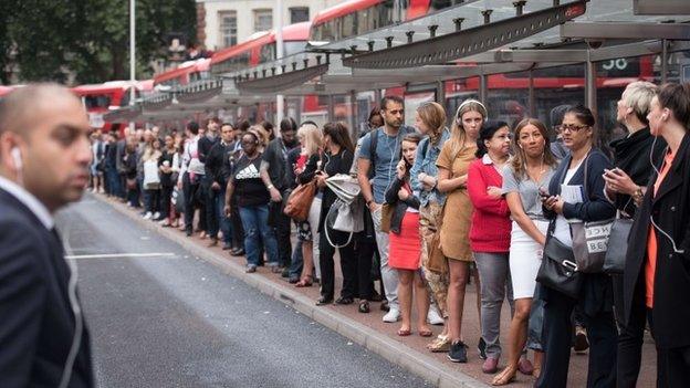 Commuters queue for buses on 6 August