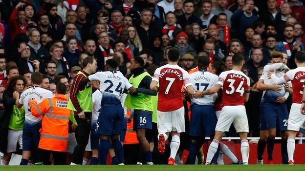 Arsenal and Tottenham players clash