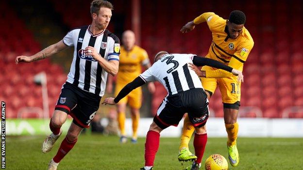 Jamile Matt is is challenged by Grimsby's Sebastian Ring
