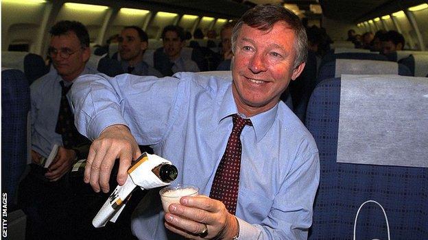 Sir Alex Ferguson pours a glass of champagne on the plan after the Juventus match