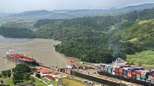 Ships pass through the Panama Canal's Pedro Miguel locks