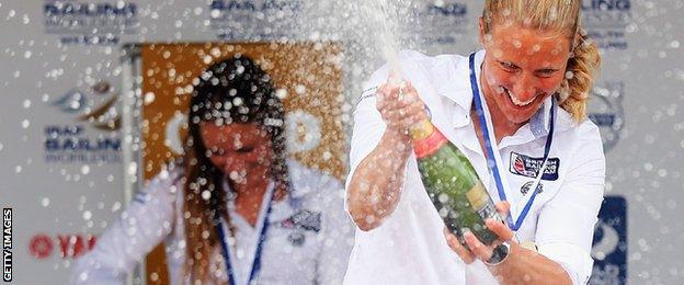 Saskia Clark sprays Champagne with Hannah Mills in the background after their 470 victory in the World Cup event in June 2015