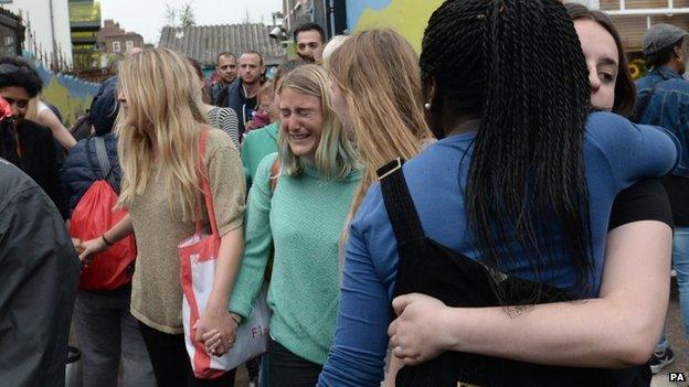 People hugging at the closure of Kids Company