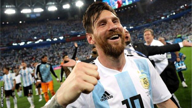 Lionel Messi punches the air to celebrate victory over Nigeria