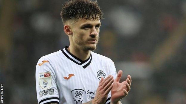 Jamie Paterson applauds Swansea's fans after his most recent appearance for the club, the defeat to Nottingham Forest on 11 December