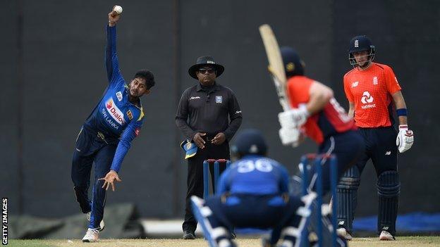 Sri Lanka's Kamindu Mendis bowls right-arm off-spin to England captain Eoin Morgan