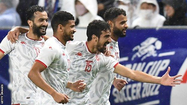 Tunisia players celebrate scoring a goal