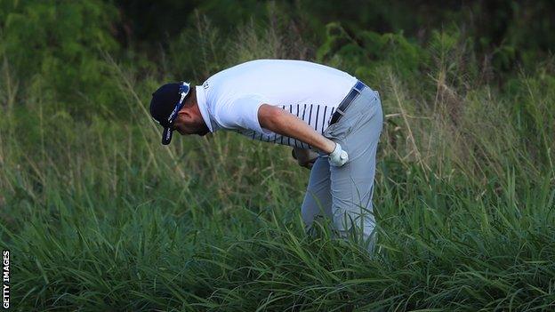 March Leishman looks for his golf ball