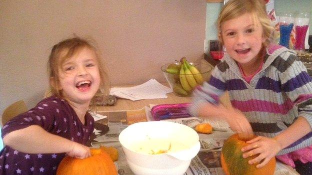 Gracie and Aimee carving pumpkins