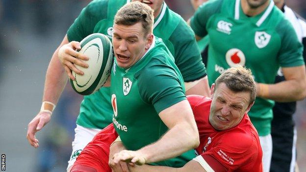 Chris Farrell is tackled by Wales' Hadleigh Parkes in Saturday's Six Nations game