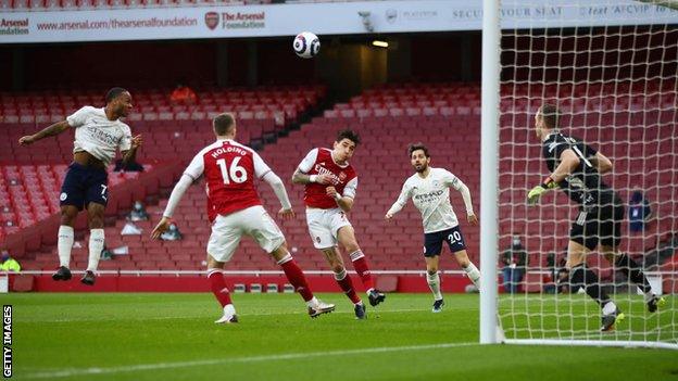 Raheem Sterling scores the opener for Manchester City at Arsenal