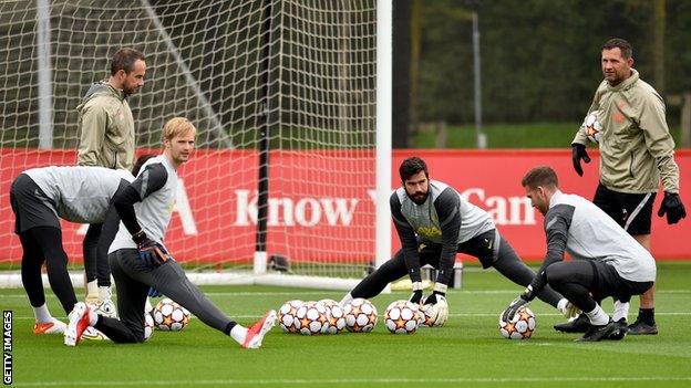 Liverpool's goalkeepers stretch during training