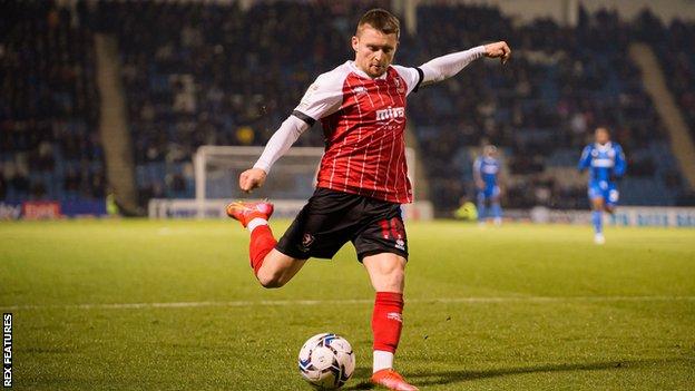 Cheltenham Town striker Alfie May takes a shot at goal