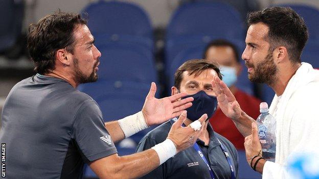 Fabio Fognini and Salvatore Caruso have a heated discussion after their Australian Open second round match