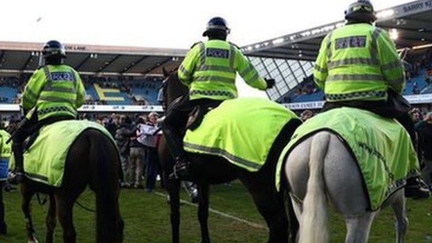 Millwall fans on the pitch following the club's 1-0 victory over Leicester City