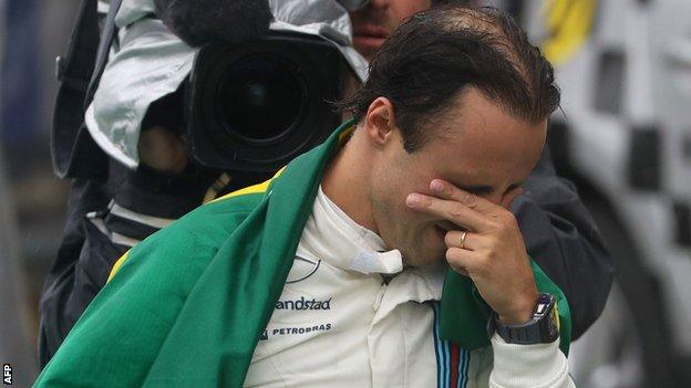 An emotional Massa as he walks down the pit lane