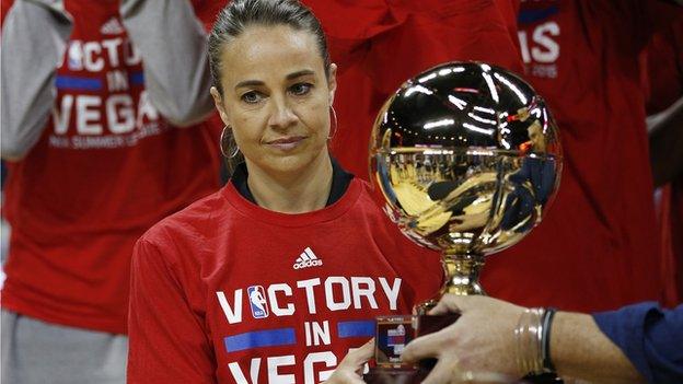 Becky Hammon receives the trophy for winning the Las Vegas Summer League