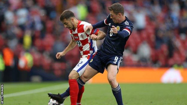 Josip Juranovic goes up against new Celtic teammate Callum McGregor at Euro 2020