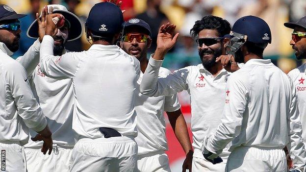 Ravindar Jadeja (third from right) celebrates taking a wicket with his India team-mates