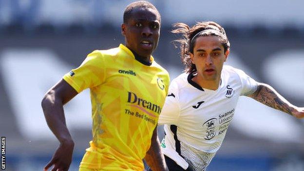 Dennis Adeniran (left) in action for Wycombe