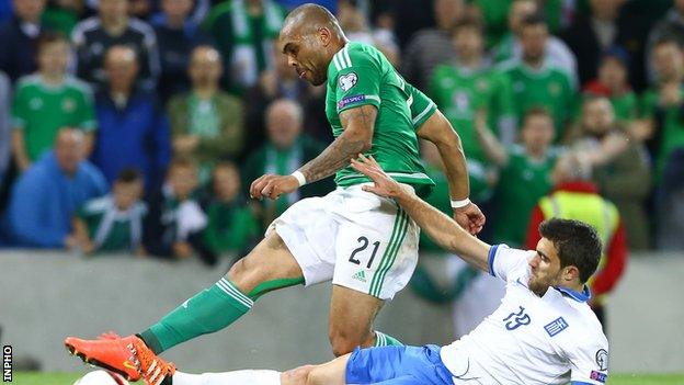 Northern Ireland's Josh Magennis is tackled by Greece's Sokratis Papastathopoulos in the Euro 2016 qualifier at Windsor Park