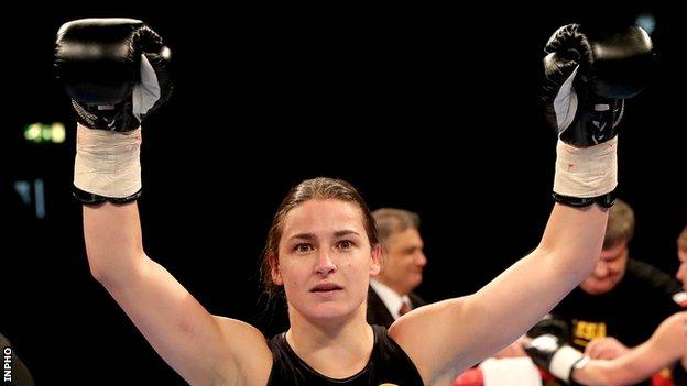 Katie Taylor celebrates after winning her first professional contest on Saturday