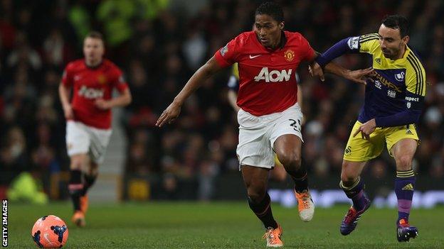 Leon Britton in action against Manchester United's Antonio Valencia