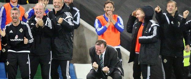 Michael O'Neill (crouching) celebrates