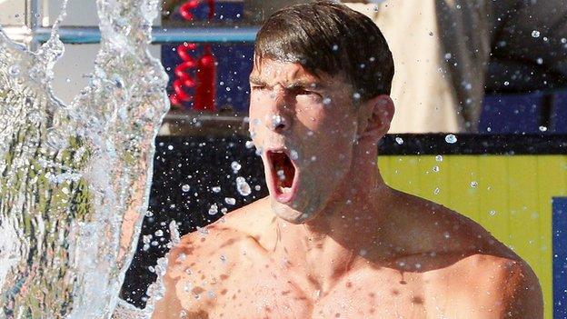 Michael Phelps celebrates his win in the 100m butterfly