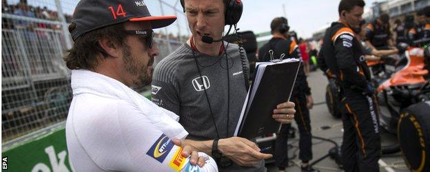 Fernando Alonso talks to his engineer