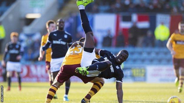 Dundee's Roarie Deacon in tackled by Nadir Ciftci