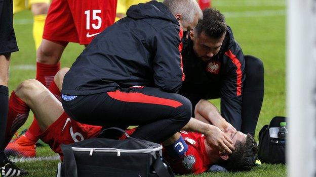 Robert Lewandowski on the floor after flare explodes