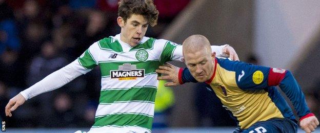 Celtic's Ryan Christie is held off by East Kilbride captain Barry Russell