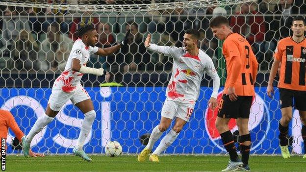 RB Leipzig players celebrate their opening goal against Shakhtar