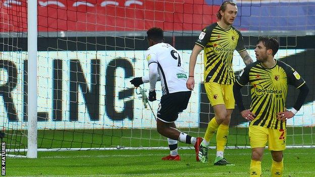 Jamal Lowe points at the camera inside Ben Foster's net after scoring Swansea's equaliser against Watford