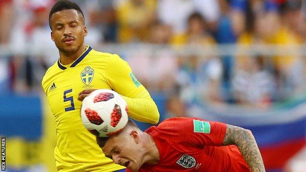 Sweden defender Martin Olsson (L) challenges Kieran Trippier of England at the 2018 World Cup