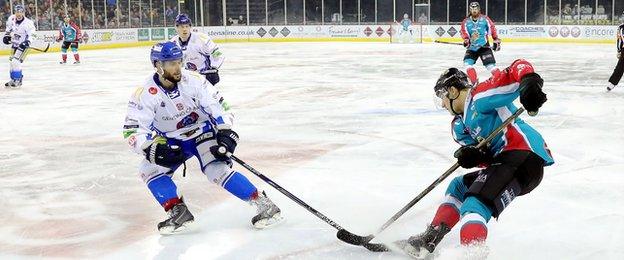 Blaze's Josh Godfrey challenges Belfast goalscorer Chris Higgins at the SSE Arena