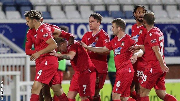 Wrexham players celebrate following Elliott Durrell's goal