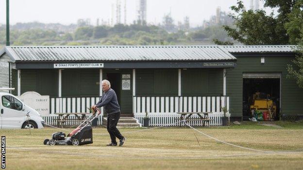 Groundsman prepares the pitch at Dinas Powys Cricket Club