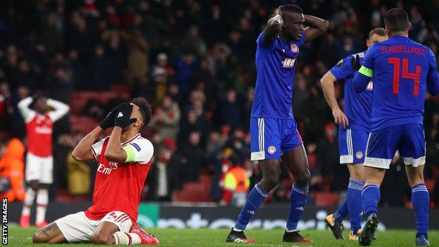 Arsenal striker Pierre-Emerick Aubameyang puts his head in his hands after a costly miss against Olympiakos in the Europa League