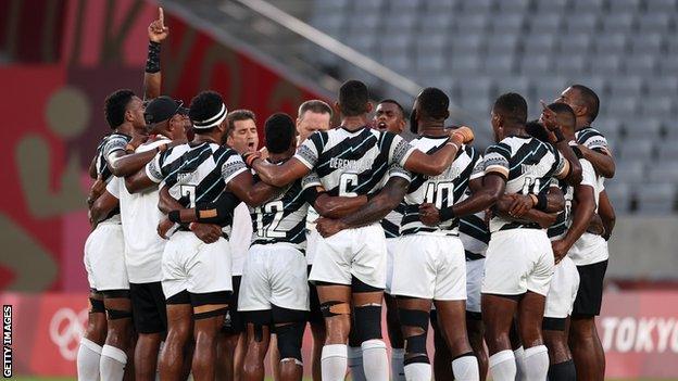 Gareth Baber celebrates with the Fiji squad after the Olympics success