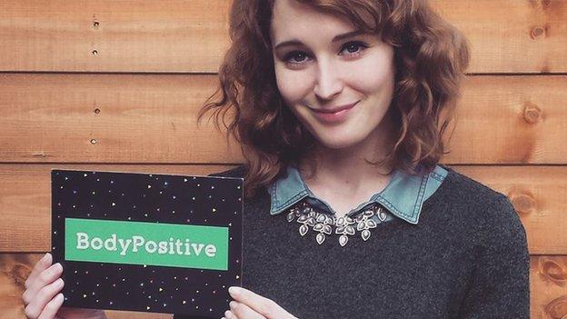 Kathryn holding a BBC BodyPositive card