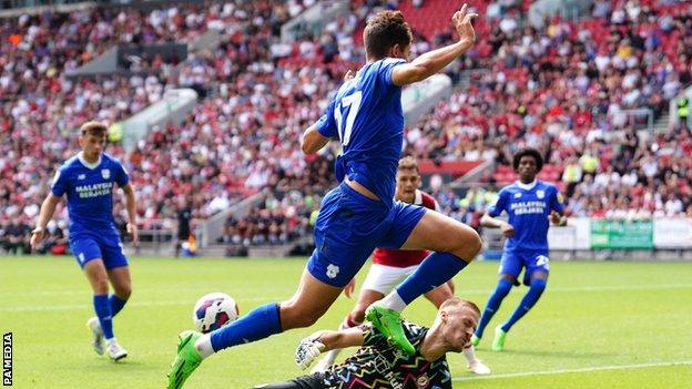 Bristol City goalkeeper Daniel Bentley bravely spreads himself to deny Cardiff City's Rubin Colwill