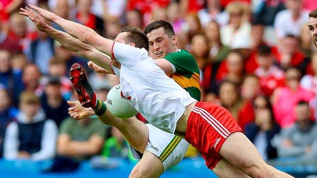 Tyrone midfielder Colm Cavanagh dives to block this shot from Dublin's Paul Murphy