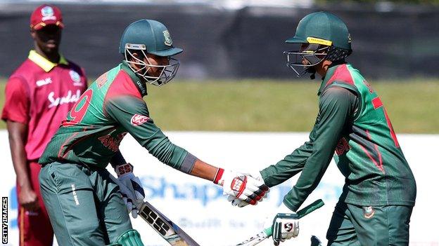 Bangladesh's Soumya Sarkar (L) shakes hands with Shakib Al Hasan (R) after reaching his half century