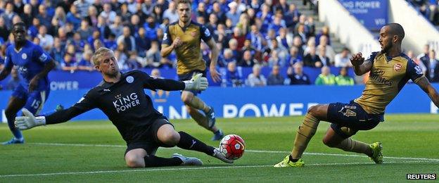 Kasper Schmeichel saves a shot from Arsenal's Theo Walcott