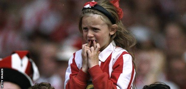 A young Sunderland fan crosses her fingers before the penalty shoot-out