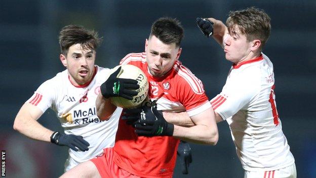 Peter Hagan of Derry attempts to escape the attention of Tyrone pair Ronan O'Neill and Mark Bradley