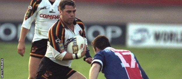 Paris Saint Germain player tries to tackle Jimmy Lowes of Bradford